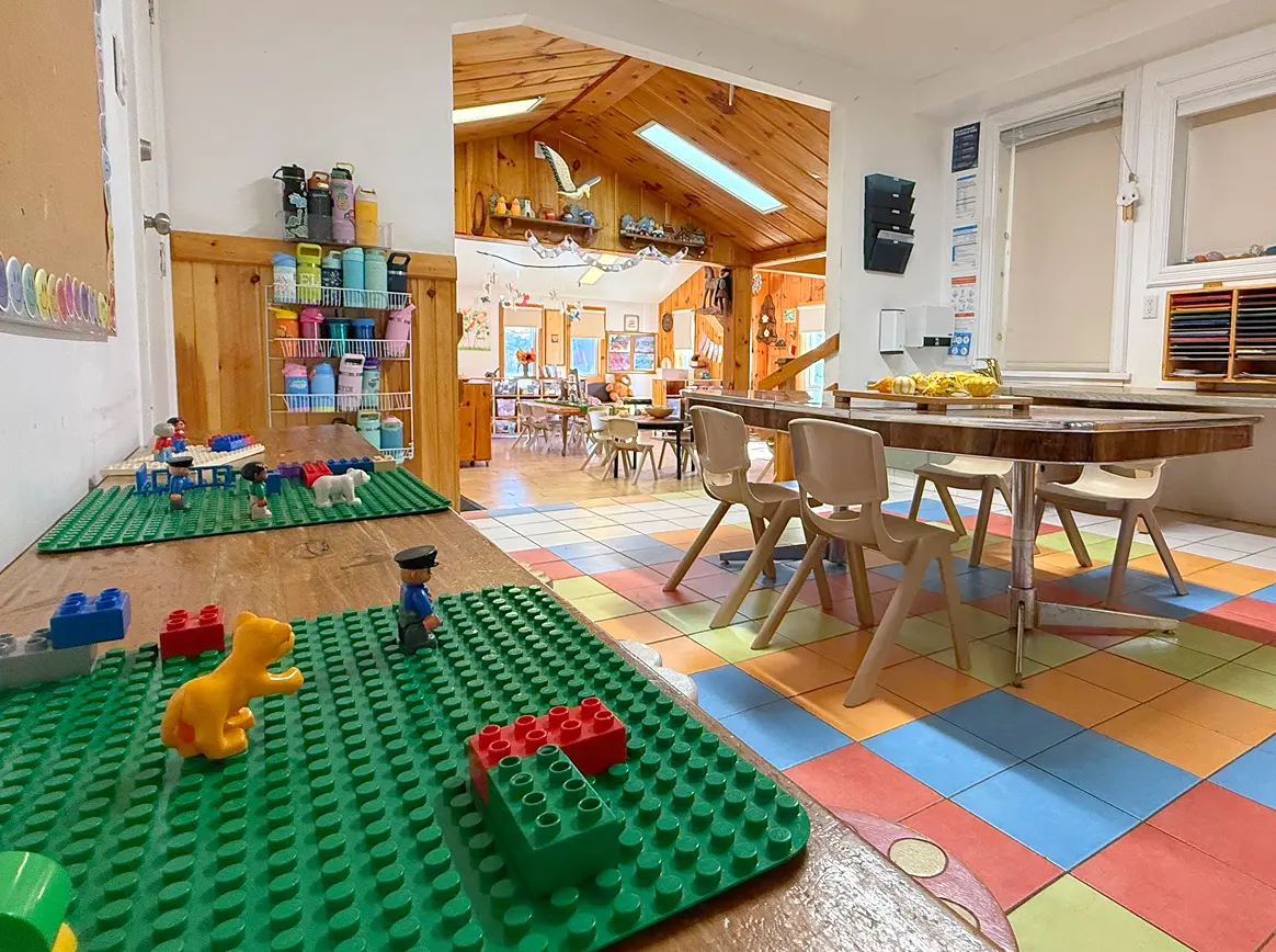 Learning Together Childcare classroom with natural wood interiors and multiple play-based learning areas