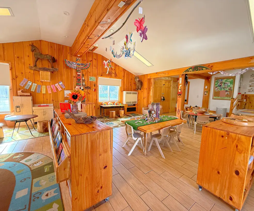 Learning Together Childcare classroom with natural wood interiors and multiple play-based learning areas