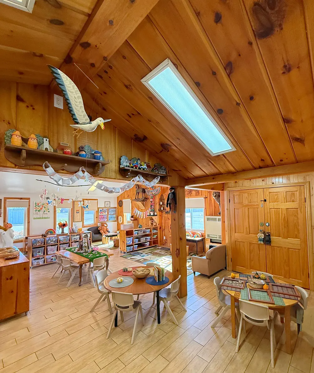 Learning Together Childcare classroom with natural wood interiors and multiple play-based learning areas