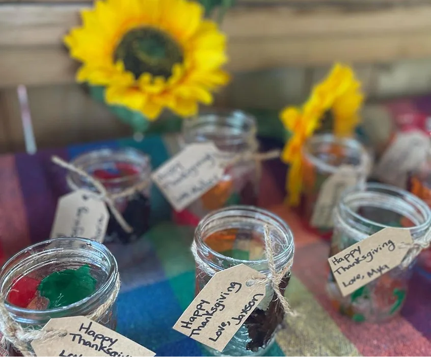 Children’s Thanksgiving crafts displayed in glass jars at Learning Together Childcare
