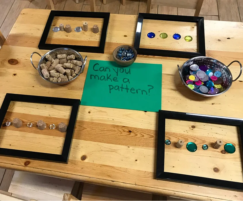 Pattern-making activity with corks, buttons and colourful stones at Learning Together Childcare